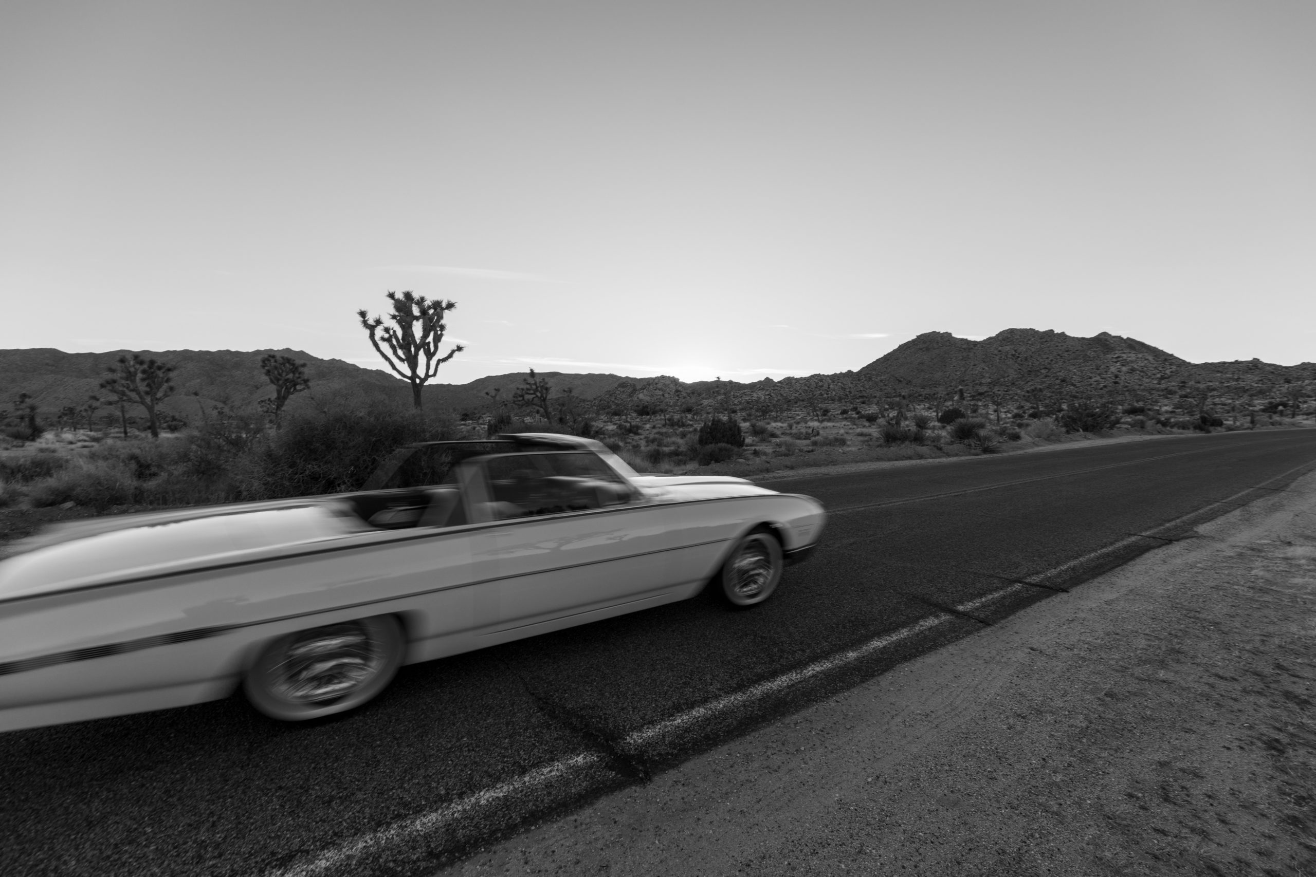 Stock photo of a blur of a white car in the desert.